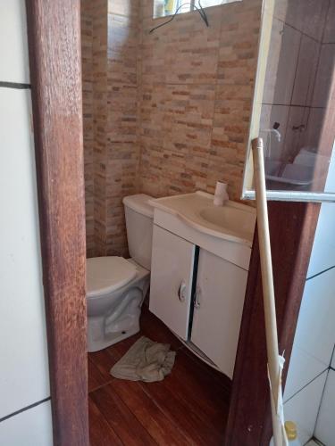a bathroom with a toilet and a sink at Casa no diamante barreiro BH! in Belo Horizonte