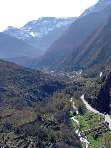 an aerial view of a valley with snow capped mountains at Atlas Pearl in Aguersioual