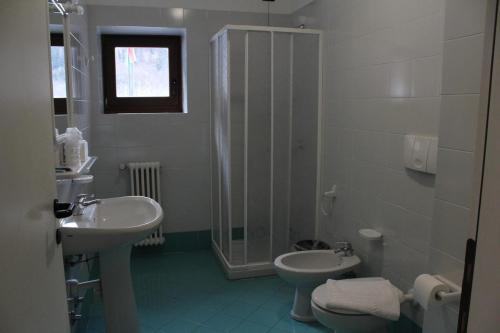 a bathroom with a sink and a toilet and a shower at Casa Corti Ostello Ristorante in Valbondione