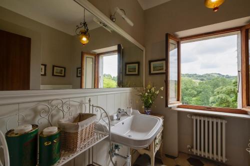 a bathroom with a sink and a window at Timeless Elegance in Poggibonsi