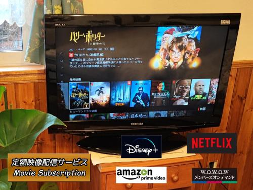 a flat screen tv sitting on top of a table at Folks House Room B in Eniwa