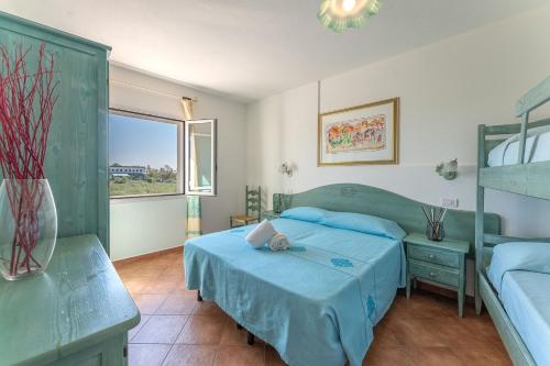 a bedroom with two beds and a window at Apartments In Golfo Orosei in Orosei