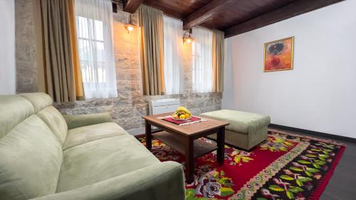 a living room with a couch and a table at Stara Čaršija Hotel & SPA in Bar