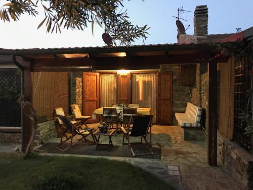 un patio avec une table et des chaises sous une pergola dans l'établissement Stintino casa con giardino vicino la Pelosa, à Stintino