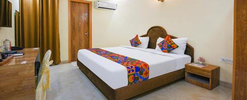 a bedroom with a large white bed in a room at Immense Residency in Faridabad
