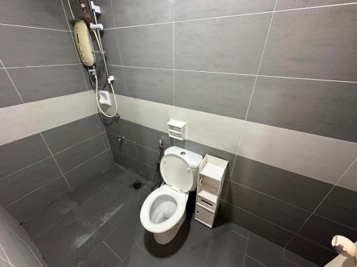 a bathroom with a toilet and a phone at TT3 SOHO near Viva Kuching in Kuching