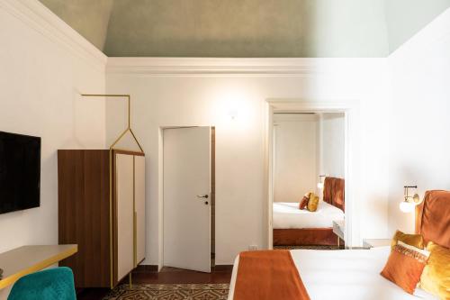 a hotel room with a bed and a bedroom at Scene Suites Apartments in Catania