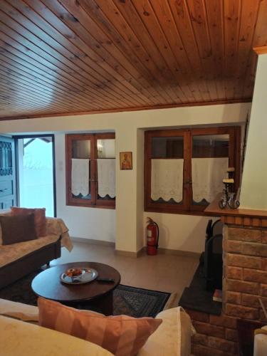 a living room with a couch and a table at Pelionature Maizonette in Makrinítsa