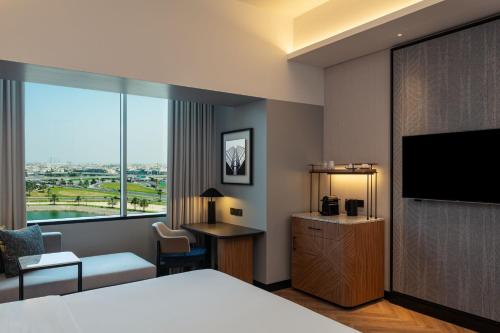a hotel room with a bed and a flat screen tv at Sheraton Mall of the Emirates Hotel, Dubai in Dubai