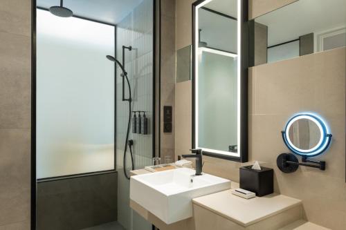 a bathroom with a white sink and a mirror at Sheraton Mall of the Emirates Hotel, Dubai in Dubai