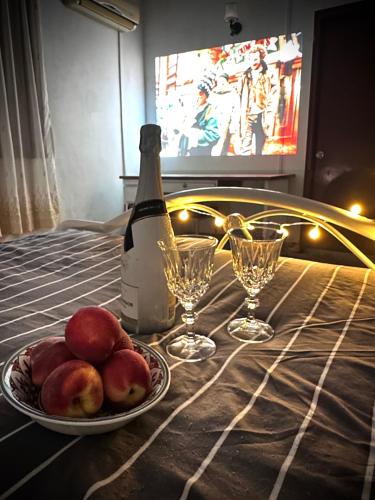 a table with a plate of fruit and a bottle of wine at Cosy Spacious Private Room with Ensuite Bath Near LRT Station in Petaling Jaya
