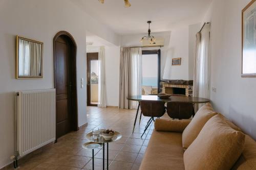 a living room with a couch and a table at Greco Levantes Villas in Triopetra