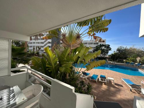 Un balcón con vista a una piscina. en The pool balcony Playa las Americas, en Csta Adje