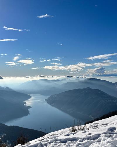 a view of a body of water in the snow at Via Scale Apartments, Lake Como, Brienno in Brienno