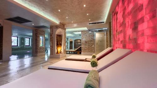 a bedroom with two beds and a brick wall at Stara Čaršija Hotel & SPA in Bar