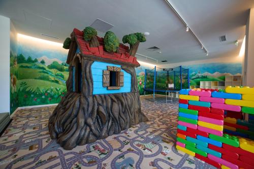a play room with a tree house in the middle at Hotel Pestera Wellness & Spa in Sinaia