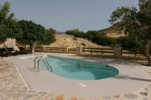 a swimming pool with a slide in the middle at Greco Levantes Villas in Triopetra