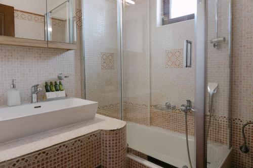 a bathroom with a sink and a shower at Greco Levantes Villas in Triopetra