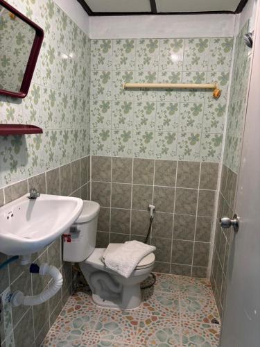 a bathroom with a toilet and a sink at Alanta aonang resort in Ban Khlong Haeng