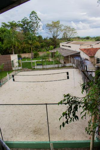 a tennis court with three tennis rackets on it at Hotel Fazenda Pé da Serra in Bom Sucesso