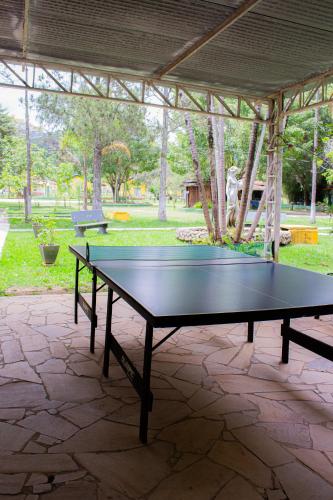 a ping pong table sitting under a pavilion at Hotel Fazenda Pé da Serra in Bom Sucesso
