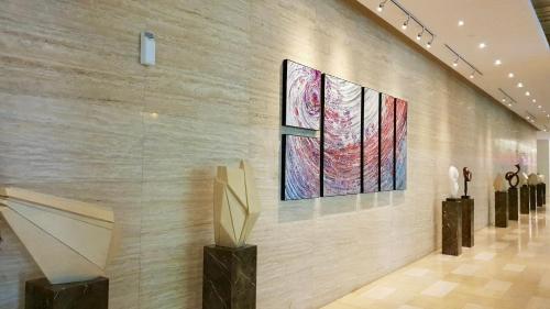 a museum with two paintings on a wall at M City Ampang KLCC Lake view Pool in Kuala Lumpur