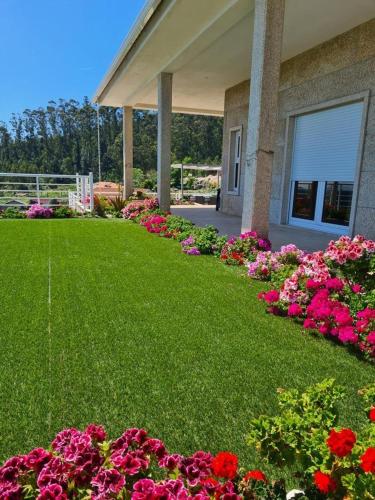 a garden of flowers in front of a house at Casa Serra dos Picos - Casa de Ferias, Braga in Braga