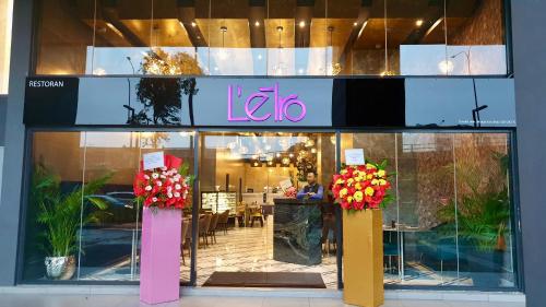 a store front of a store with flowers in the window at M City Ampang KLCC Lake view Pool in Kuala Lumpur