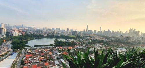 a view of a city with a river and buildings at M City Ampang KLCC Lake view Pool in Kuala Lumpur