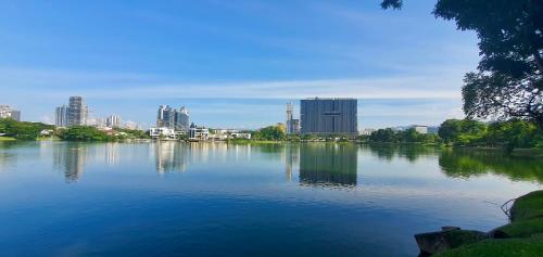a large body of water with a city in the background at M City Ampang KLCC Lake view Pool in Kuala Lumpur