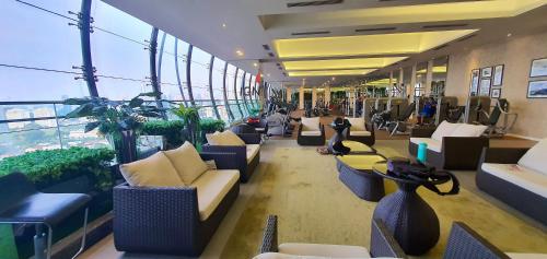 a lobby with couches and chairs in a building at M City Ampang KLCC Lake view Pool in Kuala Lumpur
