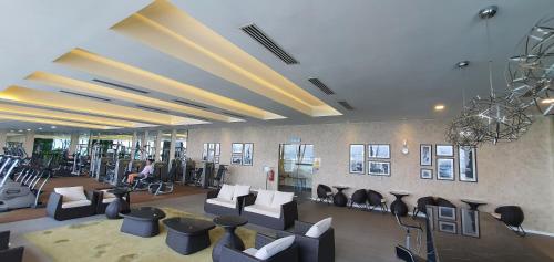 a lobby with chairs and a person in a gym at M City Ampang KLCC Lake view Pool in Kuala Lumpur