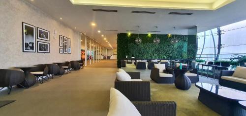 a lobby with couches and chairs in a building at M City Ampang KLCC Lake view Pool in Kuala Lumpur