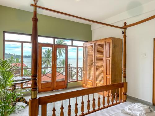 a staircase in a house with a view of the ocean at Twenty- Two Swiss Residence in Weligama