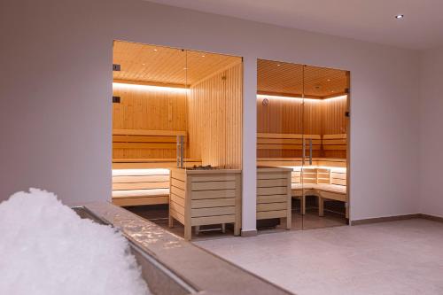 a bedroom with two bunk beds and a mirror at Bergresort Tauernblick by ALPS RESORTS in Mittersill