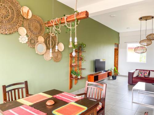 a dining room with a table and plates hanging from the wall at Twenty- Two Swiss Residence in Weligama