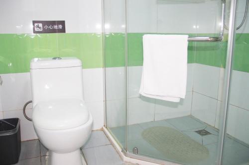 a bathroom with a toilet and a glass shower at 7Days Premium Guangzhou Tianhe Shipaiqiao in Guangzhou
