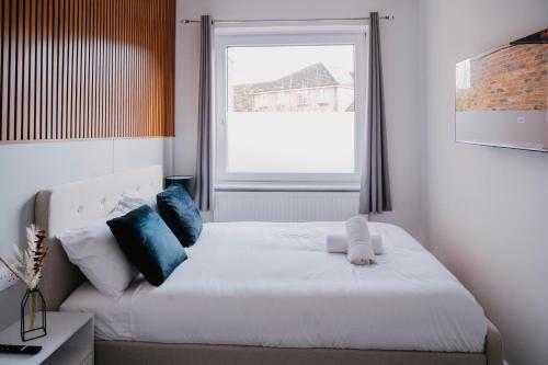 a bedroom with a white bed and a window at WNS Skylines Village in London