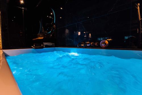a large blue hot tub in a dark room at City Spa Nijmegen in Nijmegen