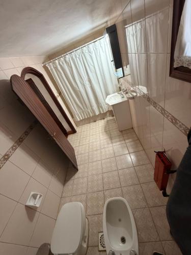a bathroom with a toilet and a sink at La Posta del Mistol in Las Tapias