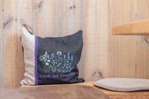 a pillow with a picture of flowers on it at Bauernhof Pergila in Maria Luggau