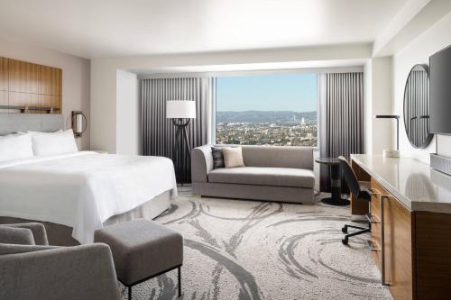 a hotel room with a bed and a desk and chair at JW Marriott Los Angeles L.A. LIVE in Los Angeles