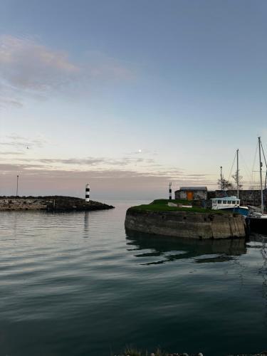 a boat is docked at a dock in the water at The Harbourview Hotel in Carnlough