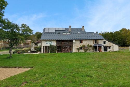 a large house with a large grassy yard at La Grange des Plans in Le Grand-Abergement