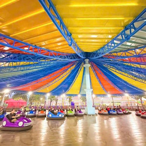 a group of people riding on bumper cars in a theme park at Suzon-Luxurious Apartment at Lumiere Boulevard VGP in Gò Công
