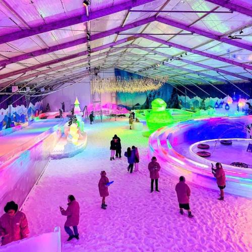 a group of people skating in an ice rink with lights at Suzon-Luxurious Apartment at Lumiere Boulevard VGP in Gò Công