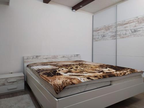 a white bedroom with a bed in a room at Rheinblickhouse in Beuggen