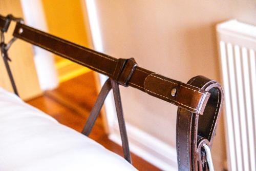 a close up of a bed with a belt on it at The Jewellery Suites Birmingham in Birmingham