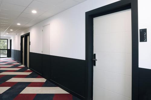 a row of doors in a hallway at Le Néliö in Aix-en-Provence