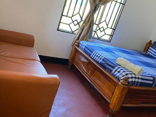 a bedroom with two beds and a window at Ushongo Econostay in Wanga